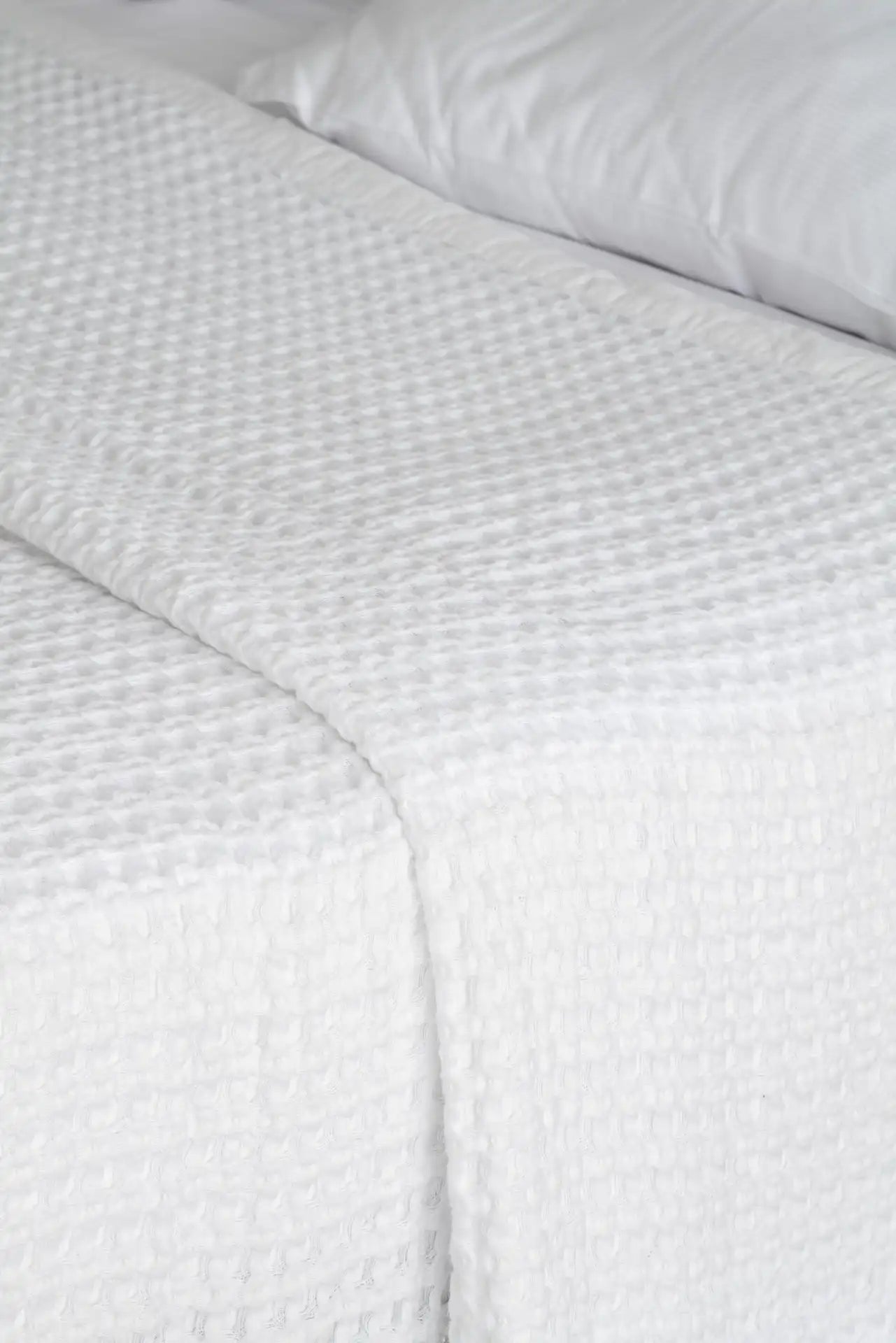 White textured bed sheet on a bed