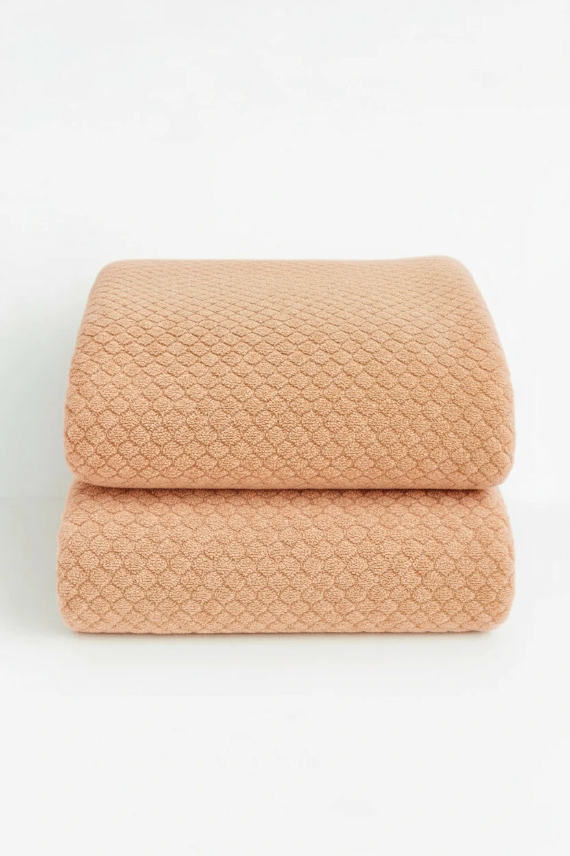 two natural colored towels are displayed as a set